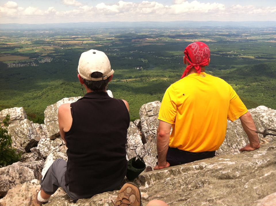 Two day hikers enjoying the mountain top view